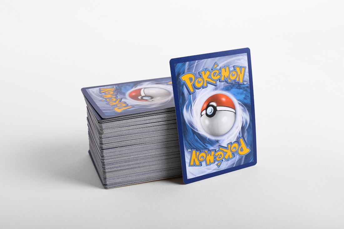 A sealed deck box beside a stack of cards